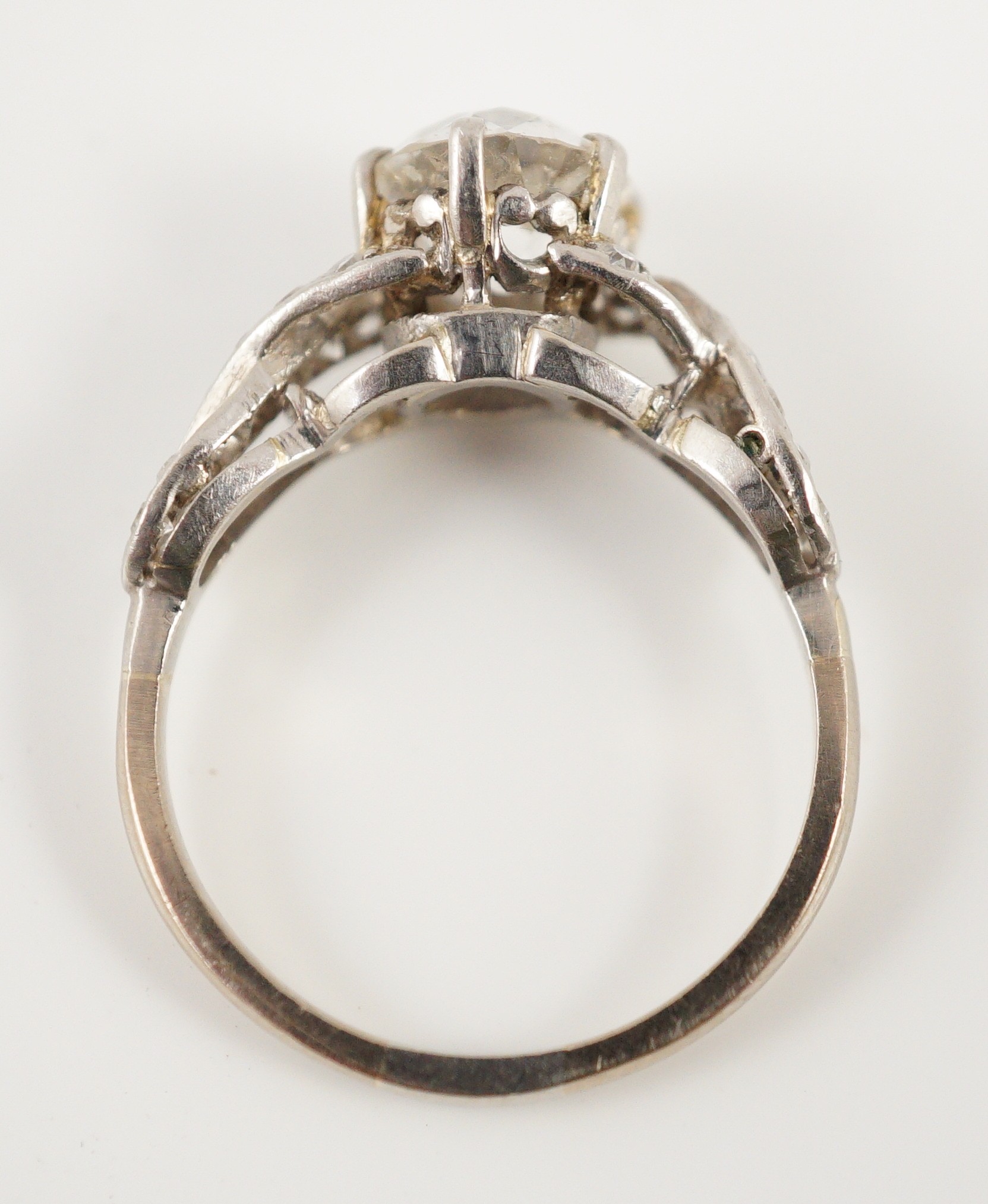 A mid 20th century white gold and single stone diamond ring, with diamond set crossover shoulders